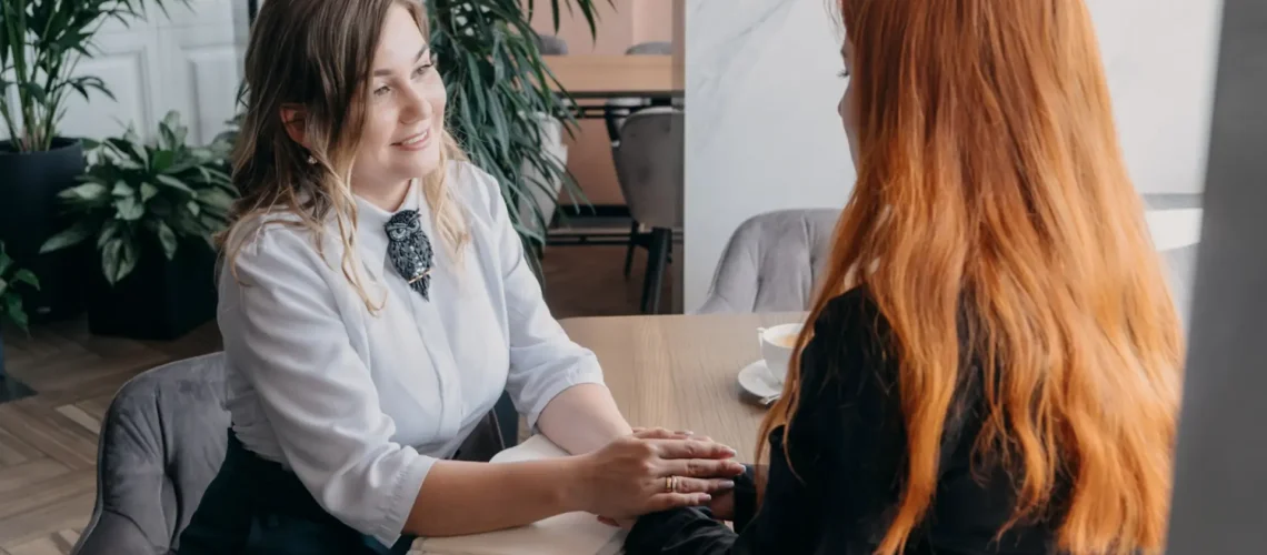 trauma-informed volunteer offers emotional support to a woman navigating addiction and trauma